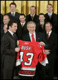 President George W. Bush receives a personalized team sweater from the Carolina Hurricane's team captain, Rod Brind'Amour, as the team was honored Friday, Feb. 2, 2007, at the White House for winning the 2006 Stanley Cup. White House photo by Paul Morse