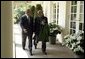 President George W. Bush and Hamid Karzai of Afghanistan walk along the colonnade after holding a joint press conference in the Rose Garden Tuesday, June 15, 2004.  White House photo by Paul Morse