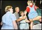 President George W. Bush and Mrs. Bush greet Crawford volunteers and their families during a luncheon to thank volunteers who have helped with events in the Crawford area, Friday, Aug. 16, 2002 in Crawford, Texas.  