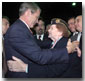 Attending the Veterans Day Prayer Breakfast at Park Avenue Seventh Regiment Armory in New York Nov. 11, President George W. Bush embraces Arlene Howard, who gave President Bush the badge from her son, George Howard, a Port Authority police officer who died at the World Trade Center. White House photo by Paul Morse.