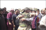 A member of the Free Iraqi Forces ,FIF, has a reunion with famly members at Umm Qasr, Iraq, on March 28, 2003. The FIF soldier is an American citizen who volunteered to help the coalition to free Iraq