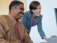 Photo of a man and a woman at computer screen.