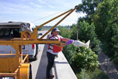 Pictures of a USGS scientist collecting a water sample. 