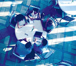 Photo: Individuals gathered around desk