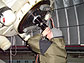 Student looking through large telescope