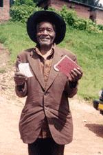 Photo of a patient proudly displaying his insurance membership card after visiting the Mulindi health center in Byumba, Rwanda.