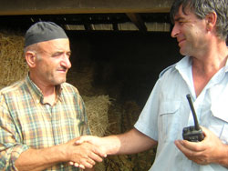 Volunteer firefighter Tane Gorgovski, right, shakes hands with Rizvan Memedovski, whose farm was saved thanks to the quick response of the Krivogastani volunteer fire department.