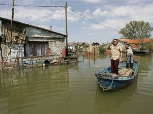 Residents negotiate waters in a flooded village near the Danube