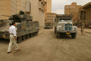 An Iraqi engineer supervises the arrival of  USAID-funded "ministry in a box" to the Iraqi Central Bank which includes desks, chairs, telephones and computers to help get the misintry get back to business. The building was looted during the war.