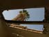 A palm tree is visible through a hole in the roof of the Al Muthenna Intermediate School, which was damaged during the war when Iraqi troops took shelter in the school. USAID partner RTI is looking at repairing the school.