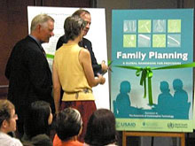 Panelists David Oot (Save the Children), Jim Shelton (USAID), and Ellen Starbird (USAID) launch “Family Planning: A Global Handbook for Providers” with a ribbon cutting ceremony.