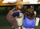 photo of kids washing montmorillonite off their hands