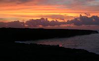 Weak glow at Highcastle ocean-entry point dwarfed by sunrise, Kilauea volcano, Hawai'i