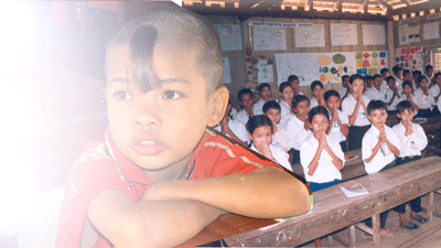 Photo of school children receiving a new curriculum on basic education. Photo: USAID/Cambodia 