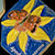 Photo: Ceramic tile of a butterfly on a flower