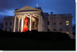 A red ribbon adorns the North Portico of the White House at dawn Monday, Dec. 1, 2008, in recognition of World AIDS Day and the commitment by President George W. Bush and his administration to fighting and preventing HIV/AIDS in America and the world. White House photo by Chris Greenberg