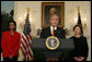 Flanked by Secretary of State Condoleezza Rice and Mrs. Laura Bush, President George W. Bush delivers a statement at the White House Friday, Oct. 19, 2007, regarding sanctions on Burma. Said the President, "The people of Burma are showing great courage in the face of immense repression. They are appealing for our help. We must not turn a deaf ear to their cries." White House photo by Chris Greenberg