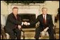 President George W. Bush welcomes Poland's President Aleksander Kwasniewski to the Oval Office Wednesday, Feb. 9, 2005. During their visit, President Kwasniewski spoke about the optimism of his government regarding the future of Iraq.  White House photo by Eric Draper