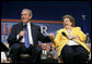 President George W. Bush and Dorothy Bourgeois share a light moment together on stage Friday, June 17, 2005, during a Conversation on Medicare in Maple Grove Minn. White House photo by Eric Draper