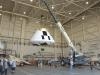 Orion pad abort crew module is lifted by a crane and placed on instrumented jacks