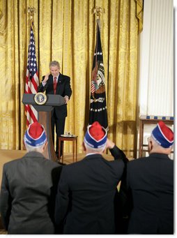 President George W. Bush salutes veterans during an event celebrating Asian Pacific American Heritage Month in the East Room Friday, May 12, 2006. "These men and women are on the front line of defending the United States of America, and in so doing, they're laying the foundation of peace for generations to come. And we're really proud of your service," said the President. White House photo by Paul Morse