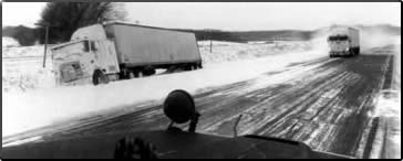 Winter scene with stranded truck off the roadside.