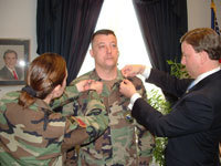 Congressman Rogers pins SFC Stollberg.