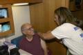 Grand Isle, LA, 11-01-05 -- Lynn Rimer RN of the Disaster Medical Assistance Team (DMAT) from NY4 gives a flu shot to Mark Costanza in the special...