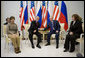 President George W. Bush and Russia's President Vladimir Putin exchange handshakes Wednesday, Nov. 15, 2006, as Mrs. Laura Bush and Lyudmila Putina look on. The brief Moscow stop was the first on the President and First Lady's week-long trip. White House photo by Eric Draper