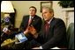 President George W. Bush answers questions from the press after meeting with the president of Georgia Mikhail Saakashvili in the Oval Office on February 25, 2004.  White House photo by Paul Morse