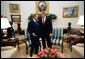 President George W. Bush talks with President Rudolf Schuster of the Slovak Republic in the Oval Office Wednesday, April 9, 2003. A member of the coalition bringing freedom to Iraq, Slovakia is contributing a nuclear/biological/chemical weapons team that is based in Kuwait.  White House photo by Eric Draper