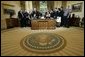 President George W. Bush delivers a Live Radio Address surrounded by Mrs. Bush and families of victims of 911 in the Oval Office, Saturday, Sept. 11, 2004.  White House photo by Eric Draper