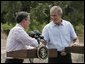 President George W. Bush and Colombian President Alvaro Uribe shake hands during a joint press conference at the President's Central Texas ranch in Crawford, Texas, on August 4, 2005.  White House photo by Paul Morse