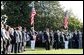 Honoring the memory of those who died during terrorist attacks on this day two years ago, President George W. Bush, Laura Bush, Vice President Dick Cheney and Lynne Cheney stand with White House staff for a moment of silence on the South Lawn 8:46 a.m., Thursday, Sept. 11, 2003.  White House photo by David Bohrer