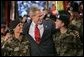 President George W. Bush joins soldiers on stage following his remarks at Fort Lewis, Washington, Friday, June 18, 2004.  White House photo by Eric Draper