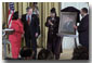 Proclaiming a holiday in honor of Martin Luther King, Jr., President George W. Bush receives a portrait of the civil rights leader from his wife and children in the East Room Jan. 21, 2002. Photographed from left to right are Coretta Scott King, the President, Rev. Bernice King and Martin Luther King III. WHITE HOUSE PHOTO BY TINA HAGER.