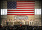 With an American flag as a backdrop, President George W. Bush addresses military personnel Monday, Aug. 4, 2008, during a stop in Alaska at Eielson Air Force Base, en route to South Korea.  White House photo by Chris Greenberg