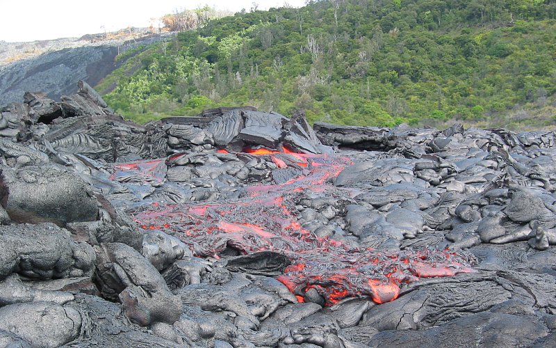 Pahoehoe flow moves along base of Pulama Pali, Kilauea Volcano, Hawai`i 