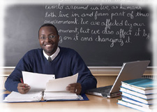 Photo of a teacher sitting at a desk