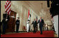 President George W. Bush and Iraqi Prime Minister Nouri al-Maliki walk through the Cross Hall to the East Room where the two leaders held a joint press conference Tuesday, July 25, 2006. "You have a strong partner in the United States of America, and I'm honored to stand here with you, Mr. Prime Minister," said President Bush. "It's a remarkable and historical moment, as far as I'm concerned, to welcome the freely elected leader of Iraq to the White House." White House photo by Kimberlee Hewitt