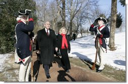 President George W. Bush is escorted by Gay Hart Gaines, Regent of the Mount Vernon Ladies Association, as President Bush and Mrs. Laura Bush arrive Monday, Feb. 19, 2007 to the Mount Vernon Estate in Mount Vernon, Va., to lay a wreath at the tomb of President George Washington in honor of Washington’s 275th birthday. White House photo by Eric Draper