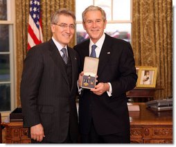 President George W. Bush stands with Robert "Robby" P. George after presenting him with the 2008 Presidential Citizens Medal Wednesday, Dec. 10, 2008, in the Oval Office of the White House. White House photo by Chris Greenberg