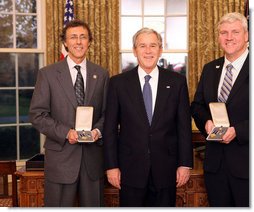 President George W. Bush stands with Jeff Miller and Earl Morse after presenting them with the 2008 Presidential Citizens Medal Wednesday, Dec. 10, 2008, in the Oval Office of the White House. White House photo by Chris Greenberg