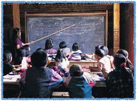 Photo of teacher in front of children's classroom