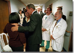 President George W. Bush and First Lady Laura Bush comfort a family member of a victim of the Pentagon terrorist attack during a visit to Washington Hospital Center, Thursday, Sept. 13, 2001. White House Photo by Eric Draper.