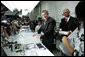 President George W. Bush tries out a keyboard that types underwater at Man & Machine, Inc. during a tour with CEO Clifton Broumand Wednesday, July 18, 2007, in Landover, Md. Man & Machine, Inc. makes water-resistant computer accessories for hospitals, medical laboratories, and industrial environments. White House photo by Chris Greenberg