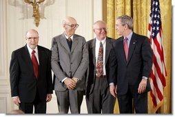 President George W. Bush awards the 2003 National Medal of Technology award to Corning Inc., scientists Ronald M. Lewis, left, Irwin Lachman, center, and Rodney D. Bagley, during a ceremony in the East Room, Monday, March 14, 2005.  White House photo by Paul Morse