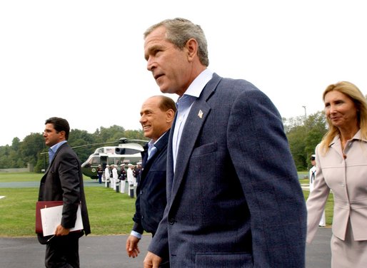 Flanked by interpreters, President George W. Bush and Italian Prime Minister Silvio Berlusconi leave a news conference after Berlusconi's arrival at Camp David, Saturday, Sept. 14, 2002. WHITE HOUSE PHOTO BY ERIC DRAPER White House photo by Eric Draper.