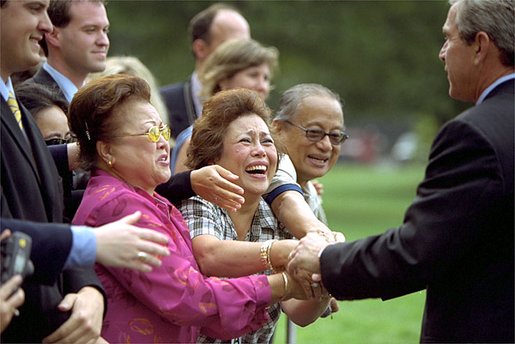 Walking toward Marine One, President George W. Bush visits with guests on the South Lawn of the White House Friday, Oct. 4, 2002. White House photo by Paul Morse.