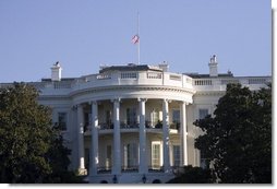 The United States flag flies at half-staff in honor of the death of Supreme Court Justice William Rehnquist, and as a mark of respect for the victims of Hurricane Katrina. White House photo by Paul Morse